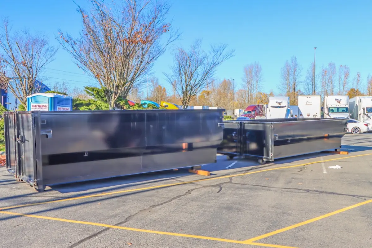 Professional dumpster rental service with roll-off container on residential driveway in Richmond West